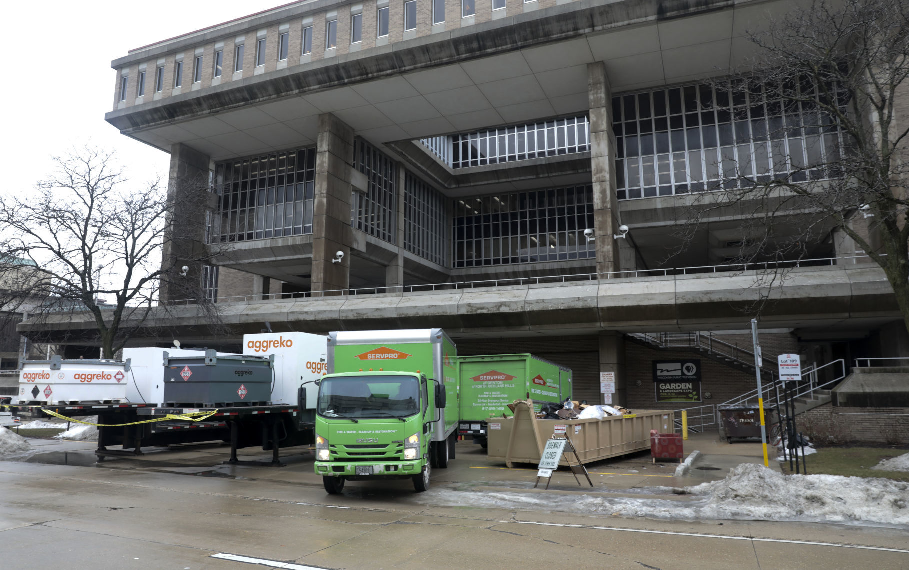 Dumpsters fill up with ruined objects at Vilas Hall